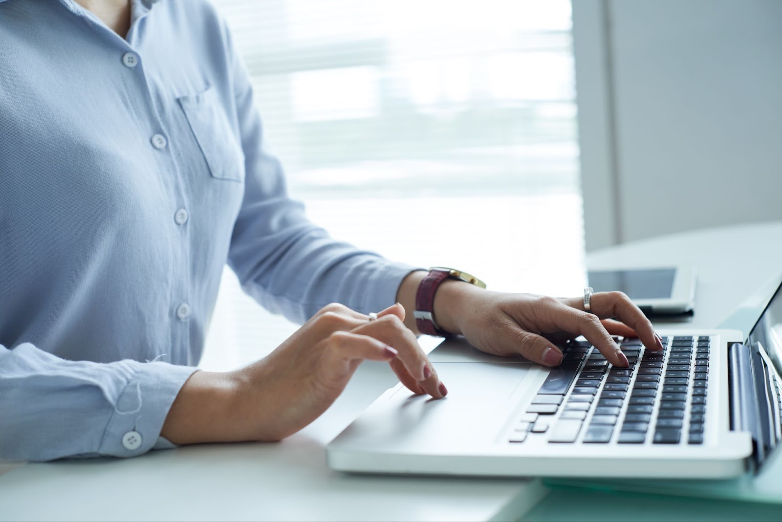 Close up of woman typing on a laptop