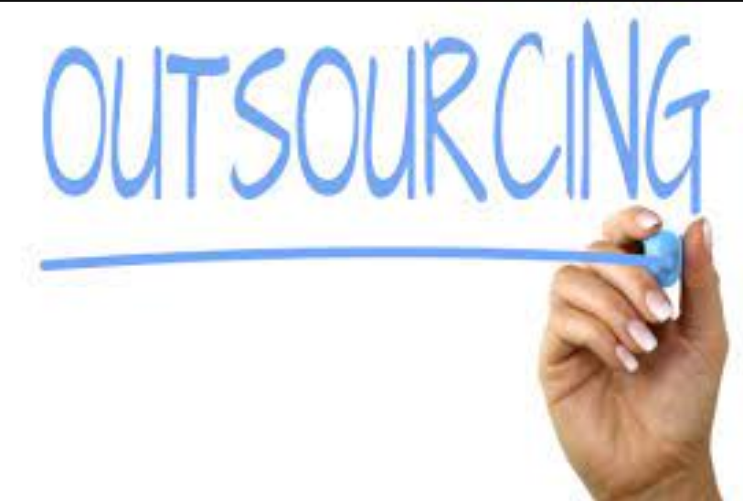 a hand writing "outsourcing" on the board with a marker